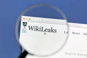 Closeup of WikiLeaks website website under a magnifying glass. WikiLeaks is an international non-profit organisation that publishes secret information