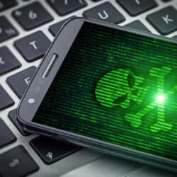 skull of death on smart phone screen. Hacked mobile phone on tablet computer