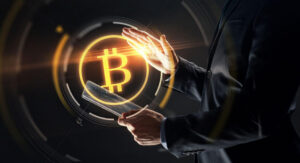 man with transparent tablet pc computer and virtual bitcoin symbol hologram over black background