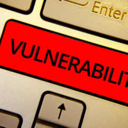 Text sign showing Vulnerability. Conceptual photo Information susceptibility systems bug exploitation attacker Keyboard brown keys yellow laptop idea create computer keypad laptop.