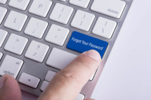 Online Concept: Finger pressing Forgot Password button on Keyboard