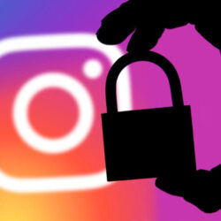 Instagram security concept. Silhouette of a hand holding a padlock infront of the Instagram logo